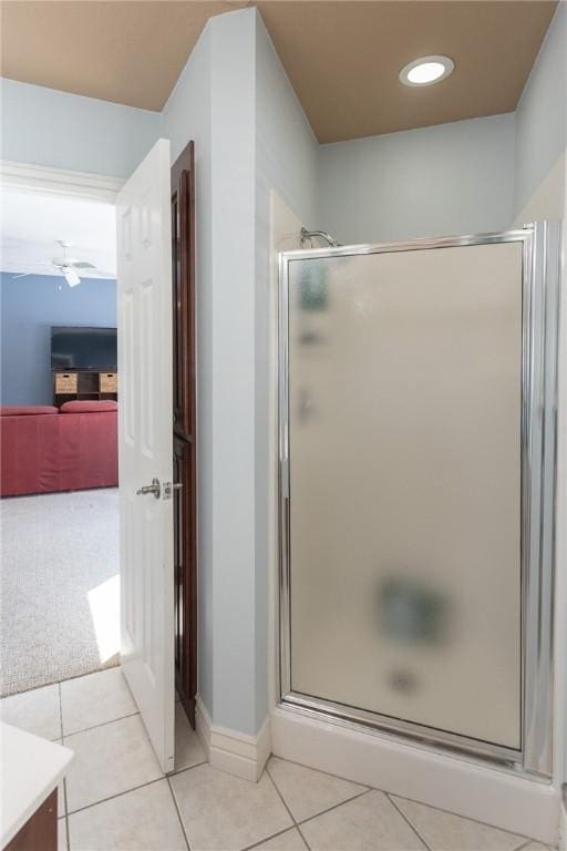 full bath with tile patterned flooring, a shower stall, and ceiling fan