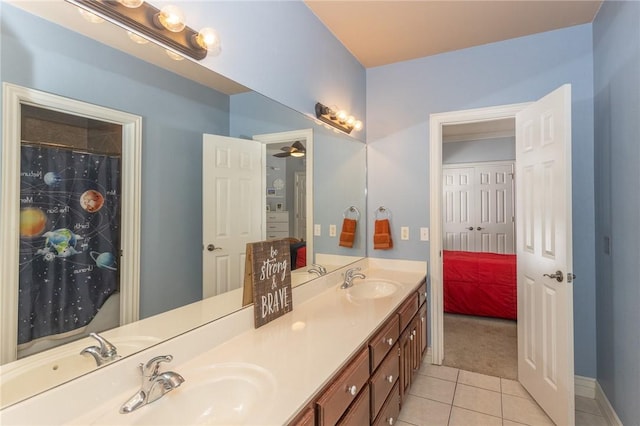 bathroom with a sink, double vanity, and tile patterned flooring