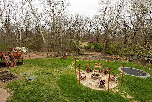 view of yard featuring a patio, an outdoor fire pit, stairs, an outdoor structure, and a deck