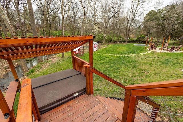 wooden terrace with a lawn, a fire pit, and a pergola