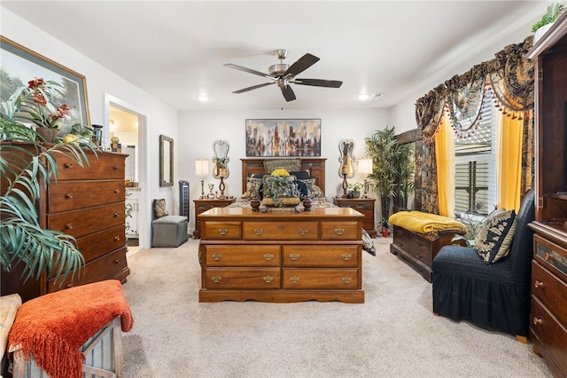 bedroom featuring light carpet and a ceiling fan