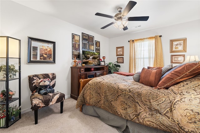 carpeted bedroom with visible vents, baseboards, and ceiling fan