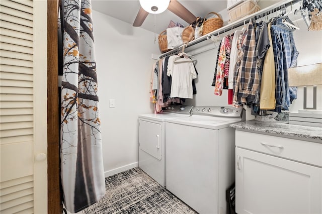 clothes washing area featuring cabinet space, independent washer and dryer, and baseboards