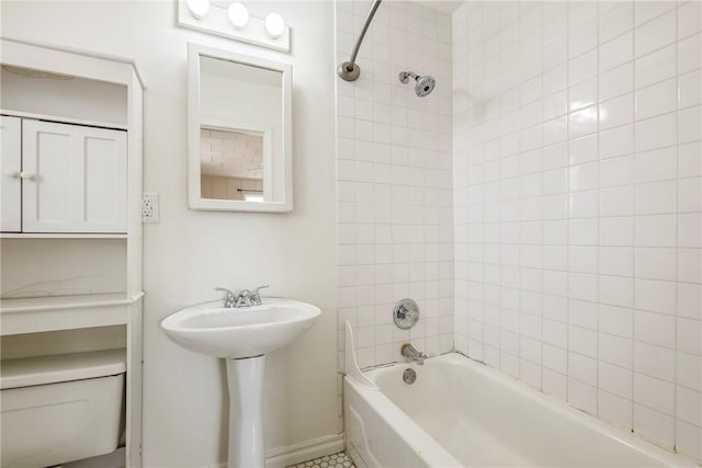 full bath with toilet, washtub / shower combination, and baseboards