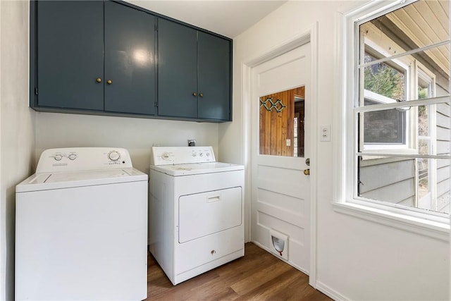 clothes washing area with dark wood-type flooring, cabinet space, and washing machine and clothes dryer