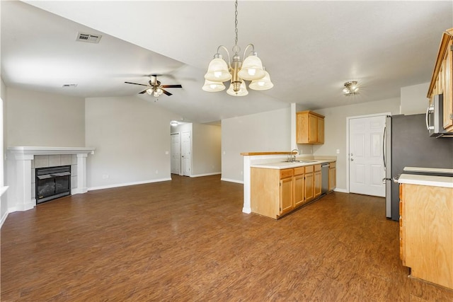 kitchen featuring visible vents, dark wood-style flooring, stainless steel appliances, light countertops, and open floor plan