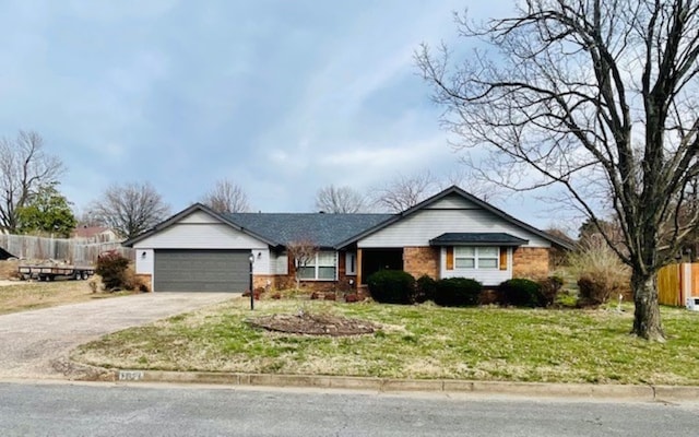 ranch-style home with fence, driveway, an attached garage, a front lawn, and brick siding