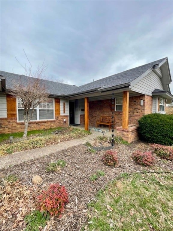 single story home featuring brick siding