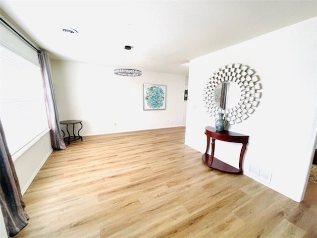 spare room with visible vents and wood finished floors