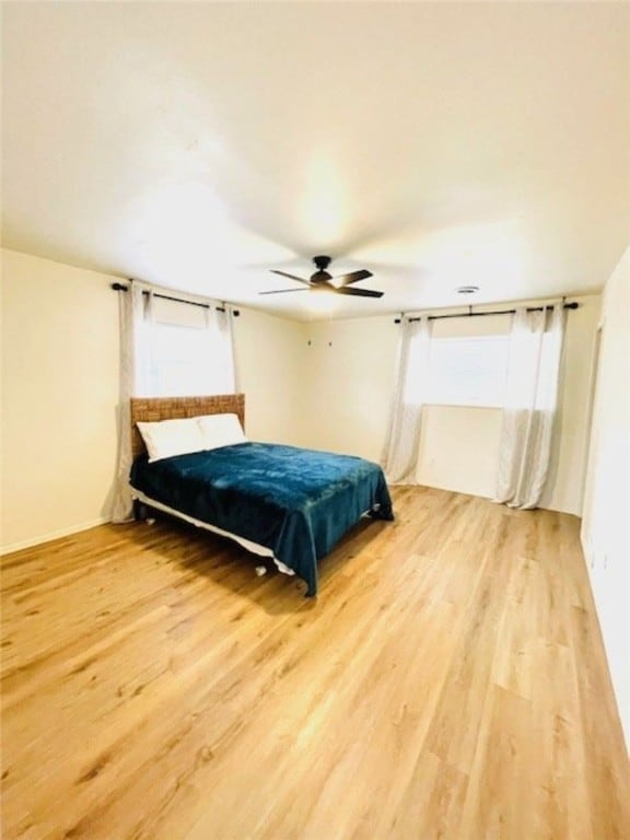 bedroom featuring a ceiling fan and wood finished floors