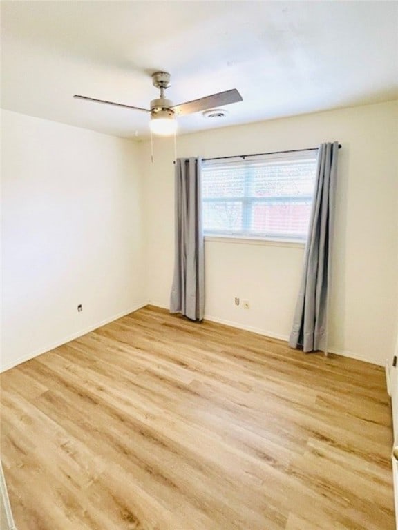 unfurnished room with light wood-style flooring and a ceiling fan