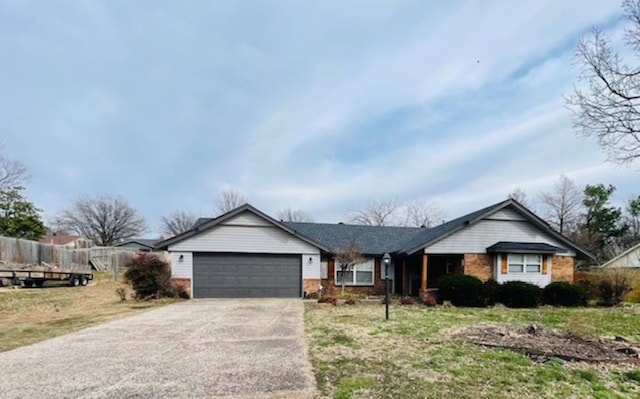 single story home with brick siding, concrete driveway, an attached garage, and fence