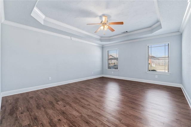 unfurnished room featuring a tray ceiling, a ceiling fan, visible vents, and dark wood-style flooring