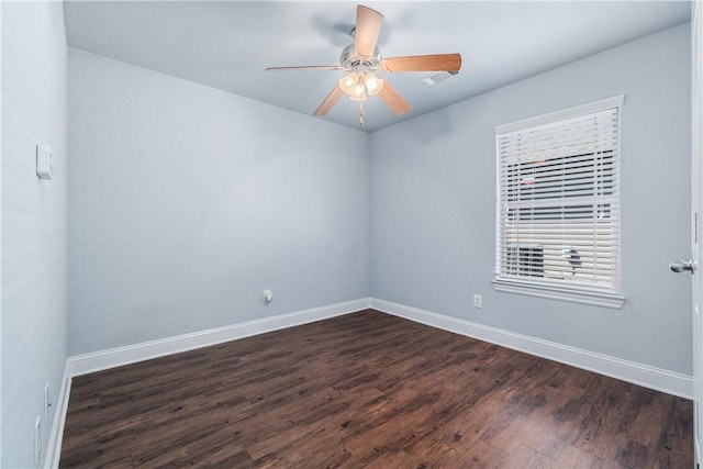 unfurnished room with a ceiling fan, baseboards, and dark wood-style flooring