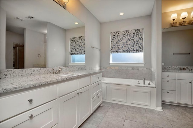 full bathroom featuring tile patterned flooring, visible vents, a garden tub, recessed lighting, and vanity