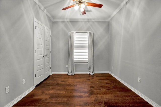 unfurnished room featuring visible vents, ornamental molding, wood finished floors, baseboards, and ceiling fan