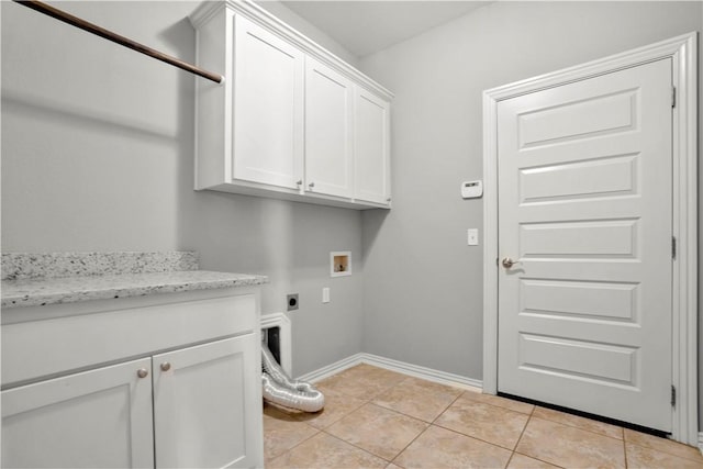 laundry room with light tile patterned floors, baseboards, hookup for an electric dryer, cabinet space, and washer hookup