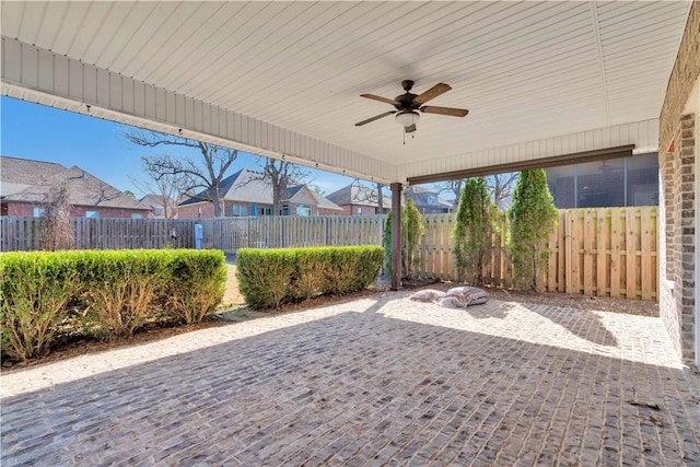 view of patio / terrace with fence and ceiling fan