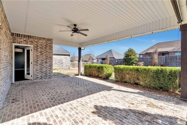 view of patio featuring fence and ceiling fan