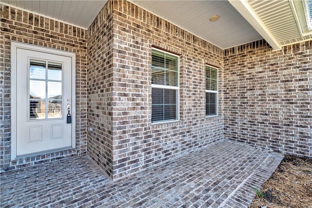 property entrance with brick siding