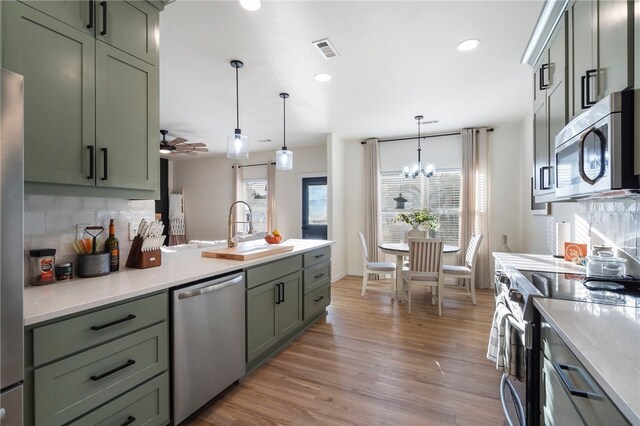 11526 Giles Rd, Farmington, AR 72730 - kitchen featuring appliances with stainless steel finishes, green cabinetry, a sink, and recessed lighting