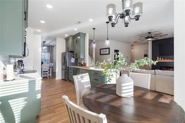 11526 Giles Rd, Farmington, AR 72730 - dining space featuring a chandelier, ceiling fan, recessed lighting, and light wood-style flooring