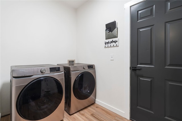 11526 Giles Rd, Farmington, AR 72730 - laundry area featuring separate washer and dryer, baseboards, and light wood-type flooring