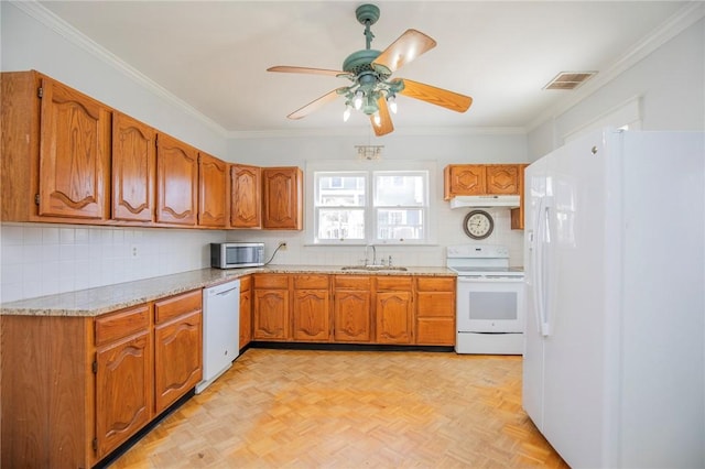 kitchen featuring visible vents, brown cabinets, a sink, under cabinet range hood, and white appliances