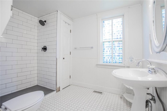 bathroom featuring visible vents, toilet, a healthy amount of sunlight, and a shower stall