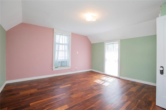 bonus room featuring vaulted ceiling, wood finished floors, and baseboards