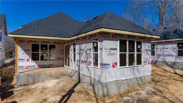 view of property exterior featuring a shingled roof