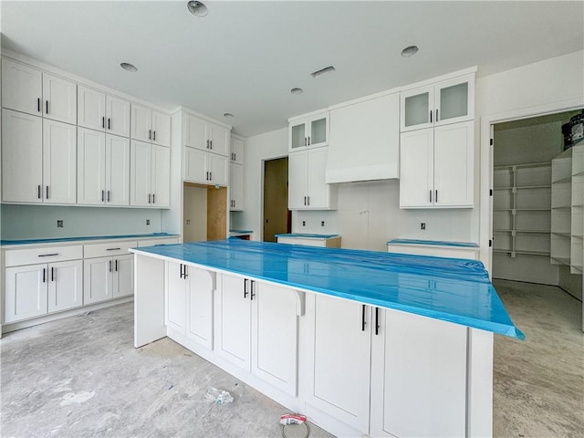 364 S College Ave, Fayetteville, AR 72701 - kitchen with a center island, white cabinets, and glass insert cabinets