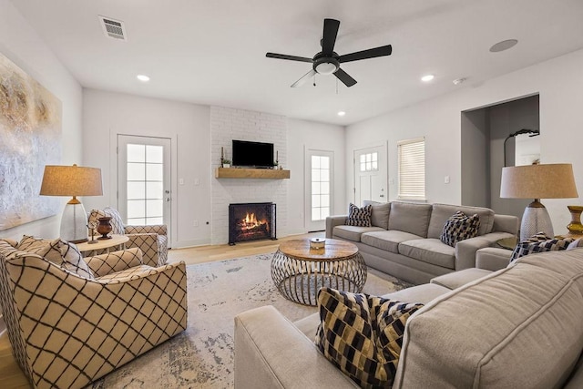 living room with visible vents, a ceiling fan, wood finished floors, recessed lighting, and a fireplace