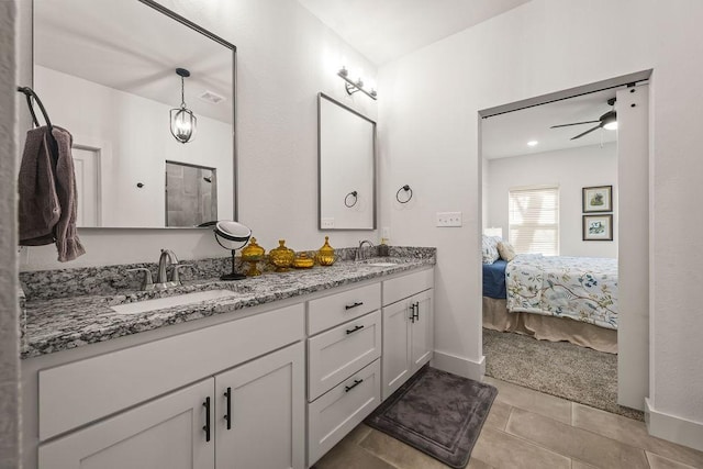 ensuite bathroom with double vanity, tile patterned flooring, ensuite bathroom, and a sink