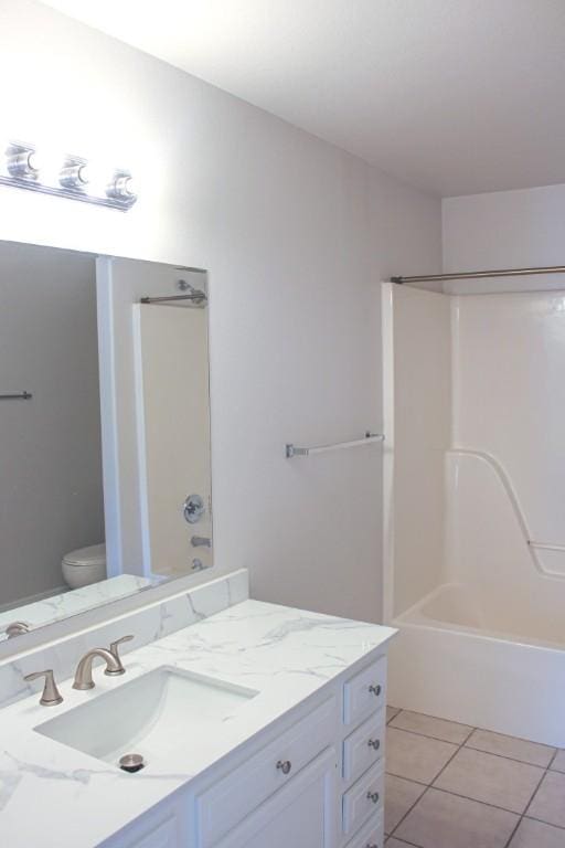 bathroom featuring tile patterned floors, vanity, toilet, and bathing tub / shower combination