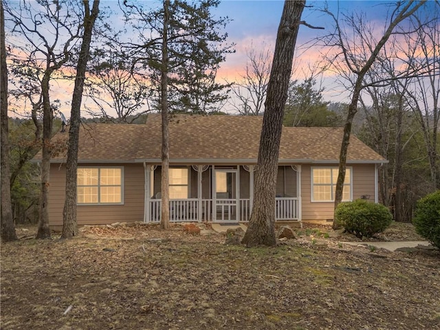 ranch-style house featuring roof with shingles