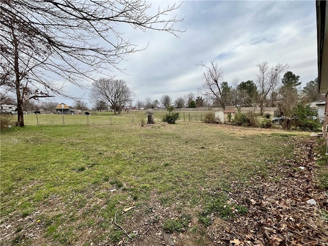 view of yard featuring a rural view and fence