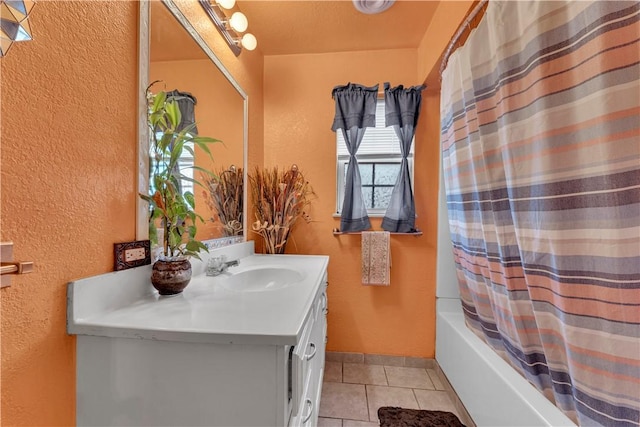 full bathroom with vanity, tile patterned floors, shower / tub combo, and a textured wall