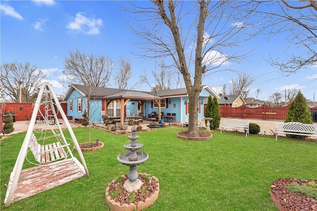 rear view of house featuring a yard, a patio area, and fence