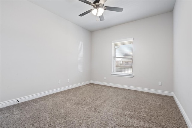 carpeted spare room with baseboards and ceiling fan