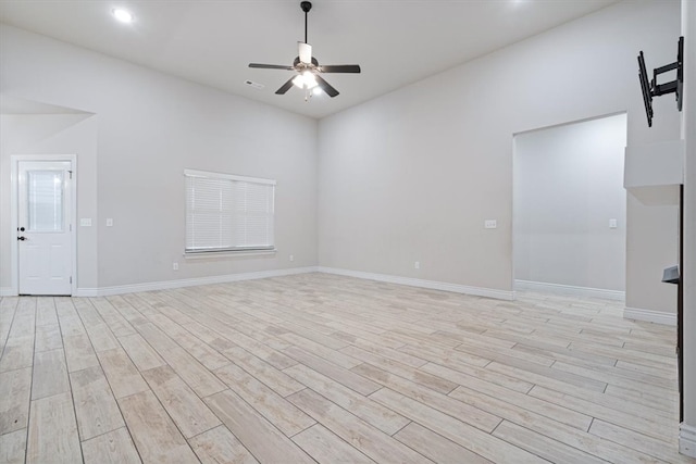 empty room featuring recessed lighting, light wood-style floors, baseboards, and ceiling fan