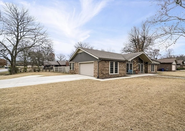 single story home with a front lawn, fence, concrete driveway, a garage, and brick siding