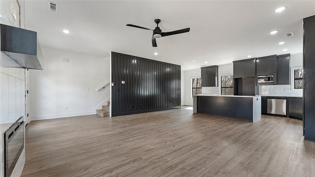 kitchen with visible vents, open floor plan, light wood-style floors, appliances with stainless steel finishes, and ceiling fan