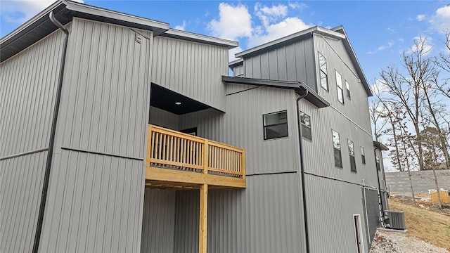 view of side of property featuring central AC unit and a wooden deck