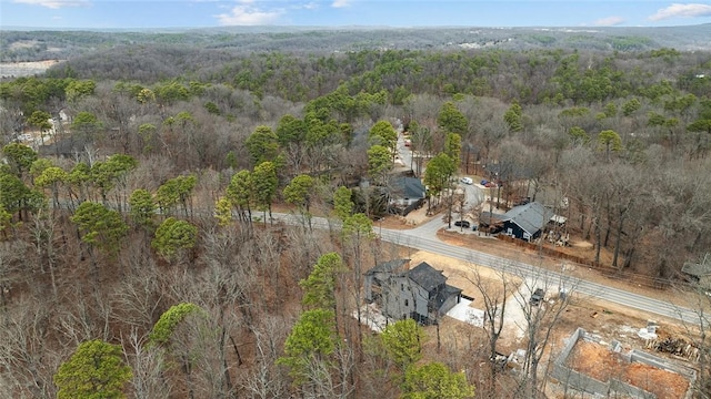 birds eye view of property with a view of trees