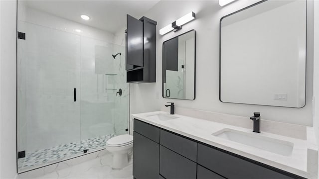 bathroom featuring marble finish floor, toilet, a shower stall, and a sink