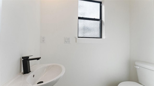 bathroom featuring toilet and a sink