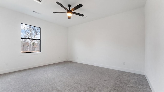 carpeted empty room featuring visible vents, baseboards, and a ceiling fan