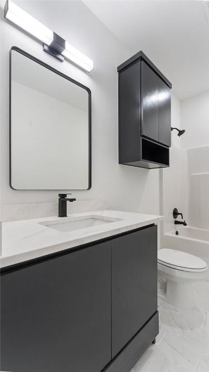 bathroom with marble finish floor, vanity, toilet, and bathtub / shower combination