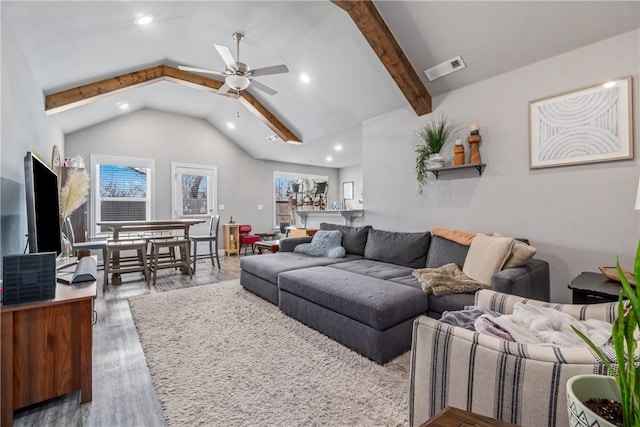 living room featuring beamed ceiling, visible vents, a ceiling fan, wood finished floors, and recessed lighting